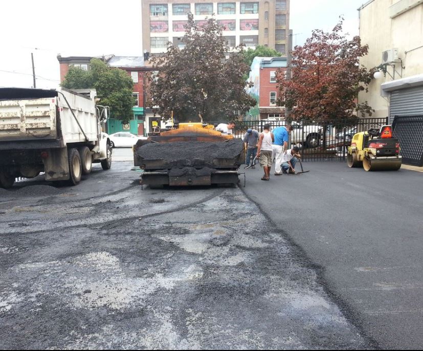 Crew performing asphalt repair in Boston